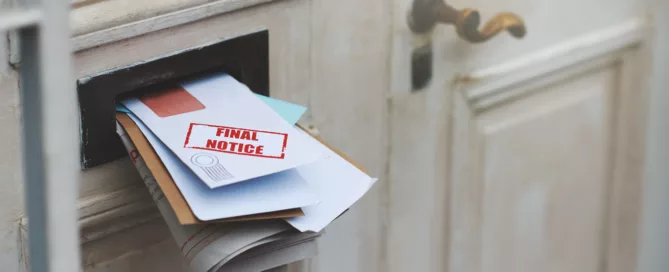 Envelopes overflowing from white door mail slot with red "Final Notice" stamp