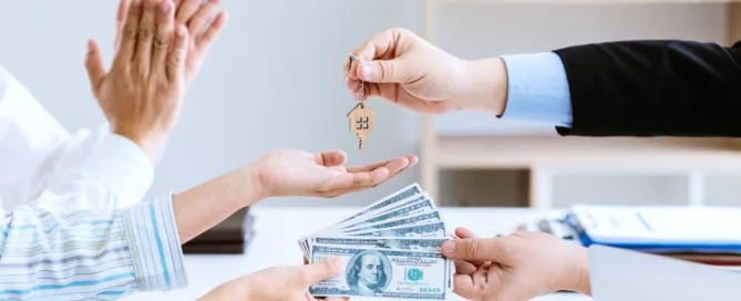 Hands exchanging house keys and cash with clapping hands in the background, symbolizing rental agreement or deposit return in Texas